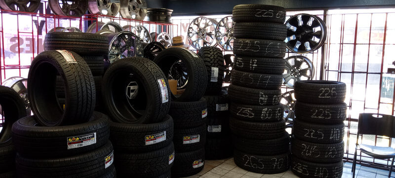 Charleston Tires interior showroom with stacked new tires and rim display